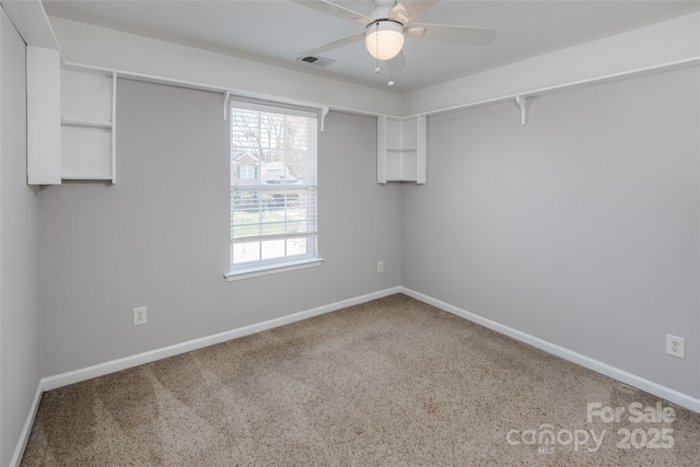 spare room with visible vents, baseboards, and ceiling fan