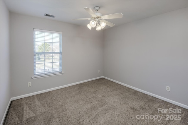 empty room featuring baseboards, carpet floors, visible vents, and a ceiling fan