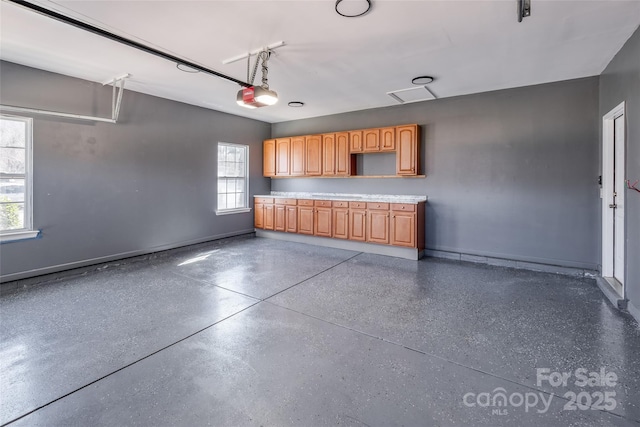 garage featuring baseboards and a garage door opener