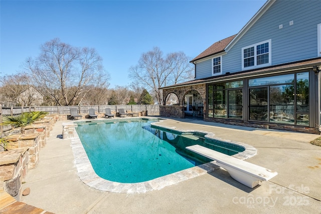 view of pool featuring a patio area, a fenced backyard, a diving board, and a fenced in pool