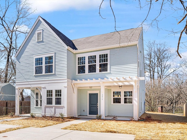 view of front of property with a porch and fence