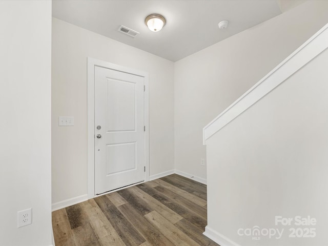 entrance foyer featuring visible vents, baseboards, and wood finished floors