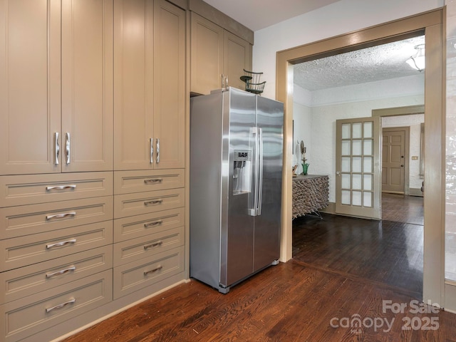 kitchen featuring a textured ceiling, stainless steel refrigerator with ice dispenser, and dark wood finished floors