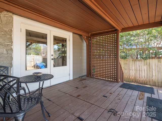 deck with french doors and fence