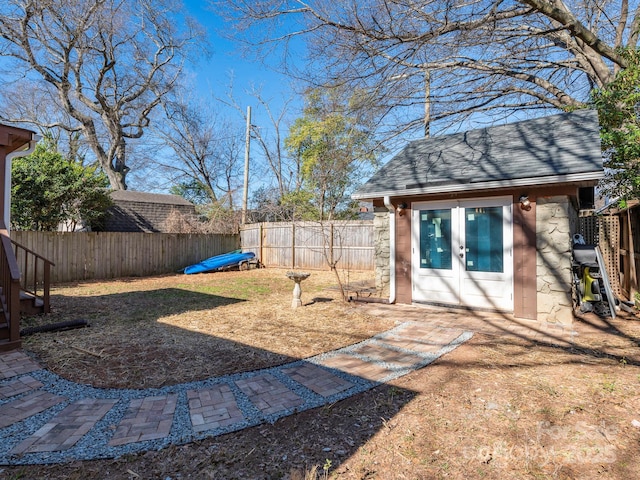 view of yard with an outdoor structure and a fenced backyard