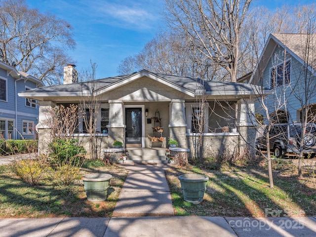 view of front of property featuring a porch and a chimney