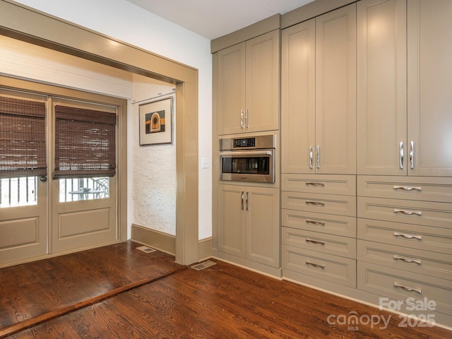 interior space with baseboards and dark wood-style flooring