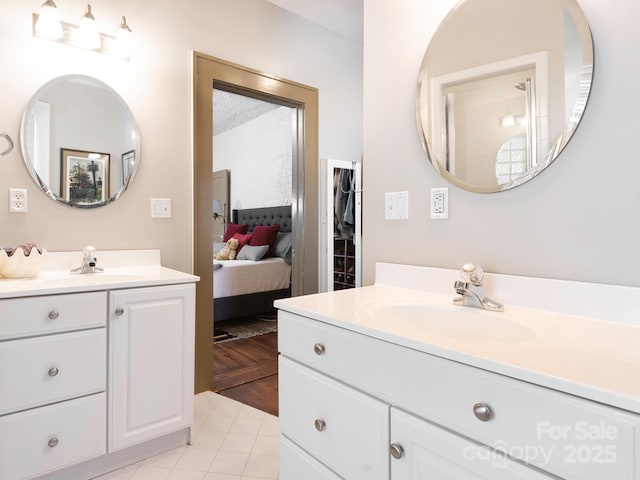 full bathroom featuring two vanities, a sink, and ensuite bathroom