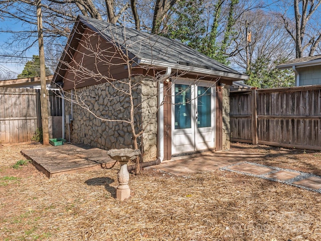 view of outbuilding featuring fence