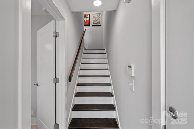 staircase featuring baseboards