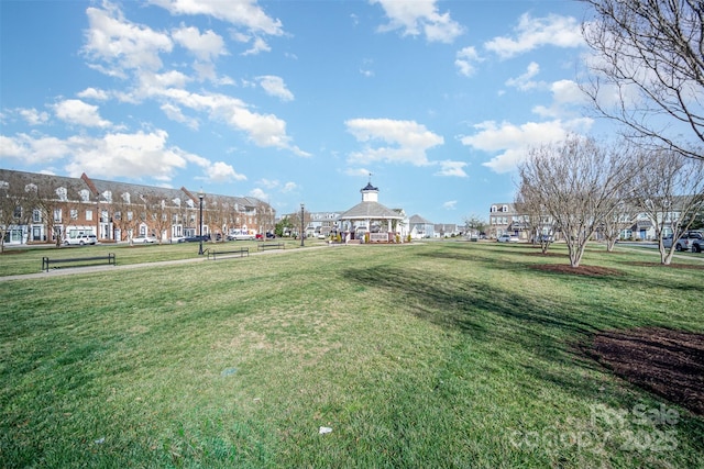 view of community featuring a residential view, a yard, and a gazebo