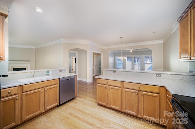 kitchen featuring arched walkways, dishwasher, a peninsula, and a sink