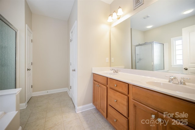 full bath with tile patterned flooring, a sink, baseboards, a shower stall, and double vanity