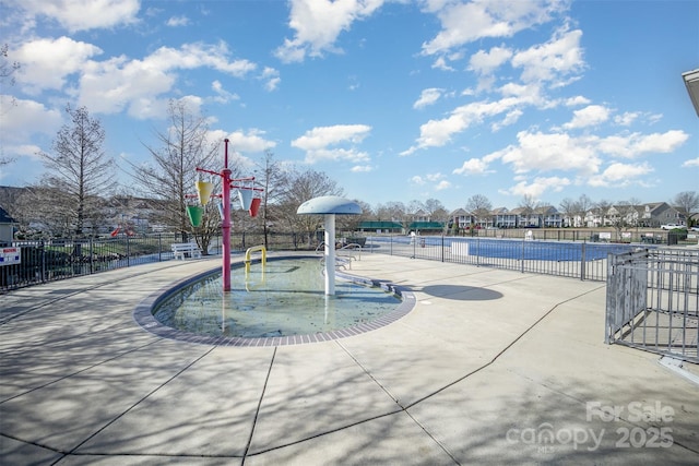 view of pool featuring fence