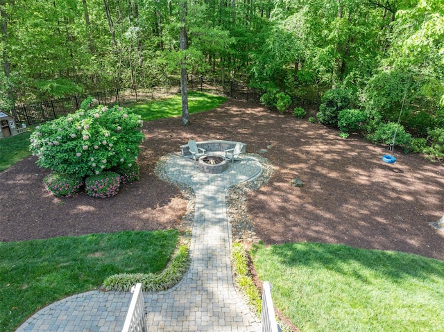 view of yard featuring a fire pit and fence