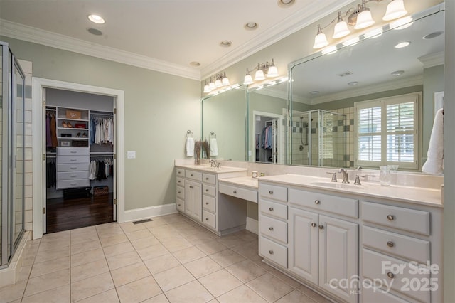 bathroom featuring a shower stall, tile patterned floors, and a sink