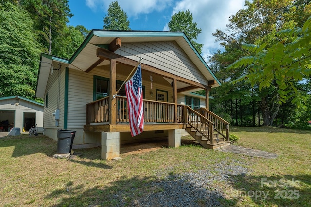 view of play area featuring an outbuilding, a lawn, and covered porch