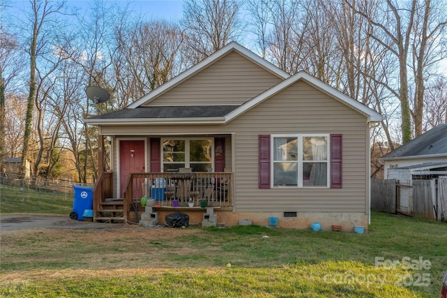 bungalow-style home with crawl space, covered porch, fence, and a front lawn