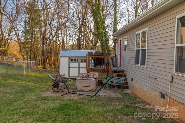 view of yard featuring an outbuilding, a storage shed, and fence