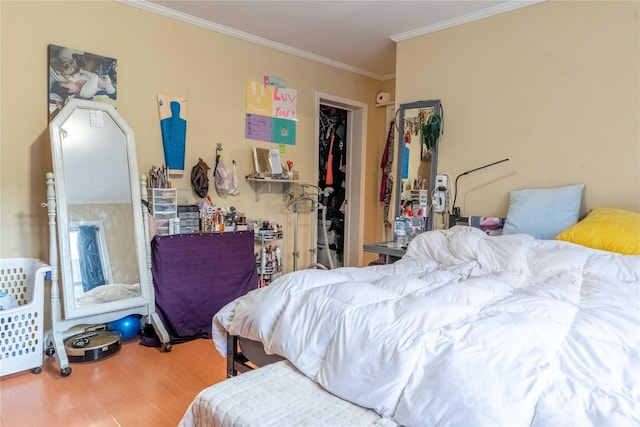 bedroom featuring ornamental molding and wood finished floors