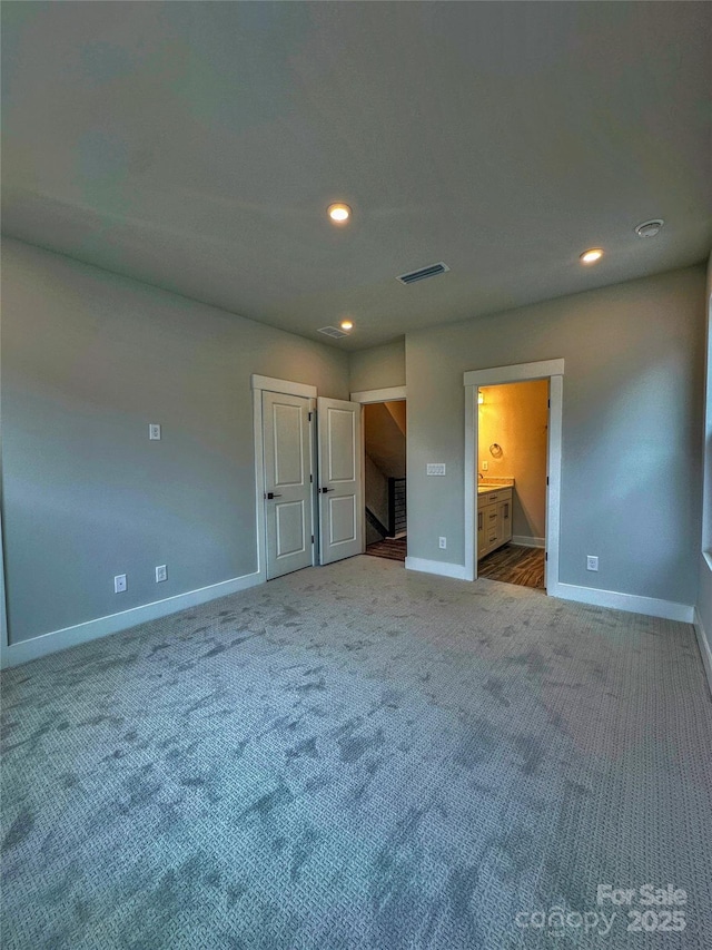 unfurnished bedroom featuring baseboards, visible vents, carpet flooring, and recessed lighting