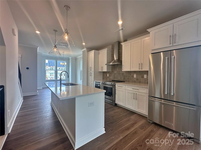 kitchen with a sink, appliances with stainless steel finishes, wall chimney exhaust hood, crown molding, and decorative backsplash