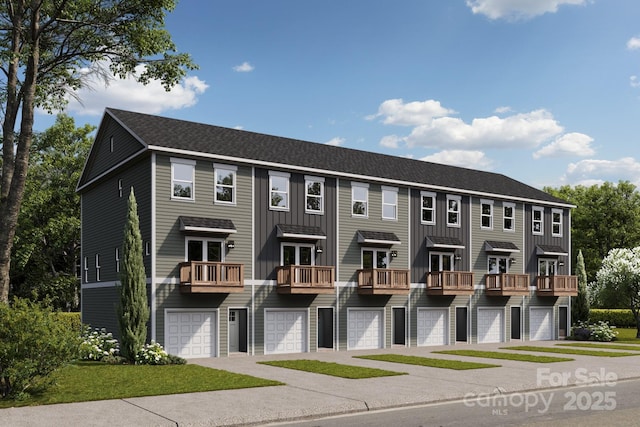 townhome / multi-family property featuring board and batten siding, a shingled roof, and an attached garage