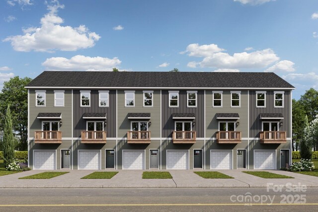 multi unit property featuring driveway, board and batten siding, and an attached garage