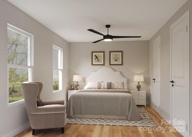 bedroom featuring wood finished floors, a ceiling fan, and baseboards