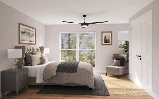 bedroom with light wood-type flooring and a ceiling fan