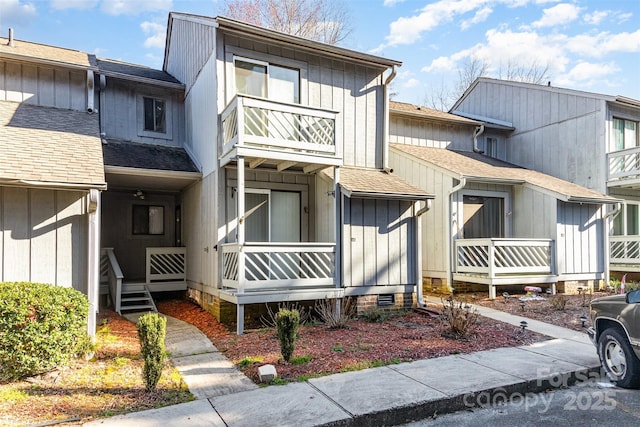 townhome / multi-family property featuring crawl space, a shingled roof, a porch, and board and batten siding