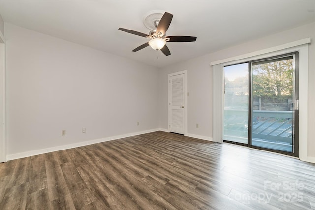 empty room with ceiling fan, baseboards, and wood finished floors