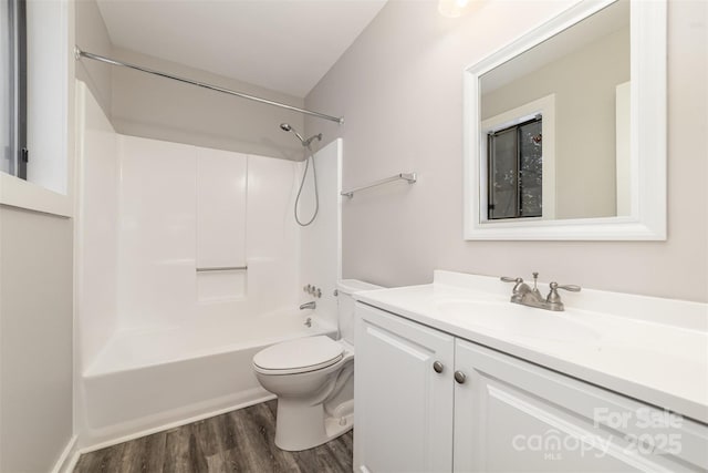 bathroom featuring shower / tub combination, vanity, toilet, and wood finished floors