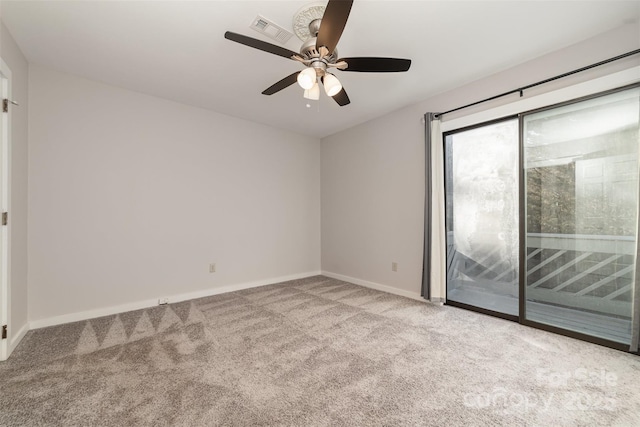 carpeted empty room with a ceiling fan, visible vents, and baseboards