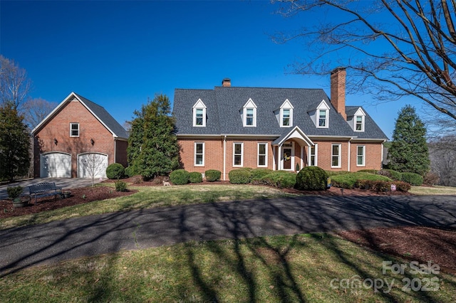 cape cod home featuring concrete driveway and brick siding