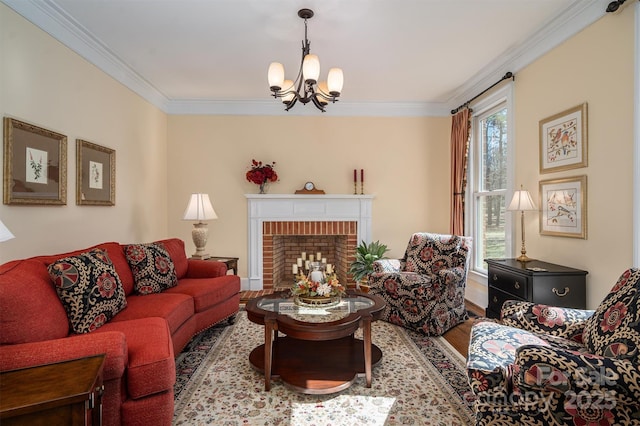 living area with ornamental molding, a brick fireplace, an inviting chandelier, and wood finished floors