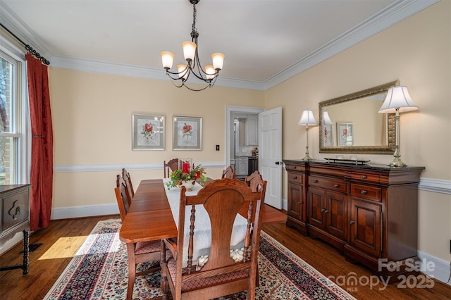 dining space featuring ornamental molding, dark wood-style flooring, baseboards, and an inviting chandelier