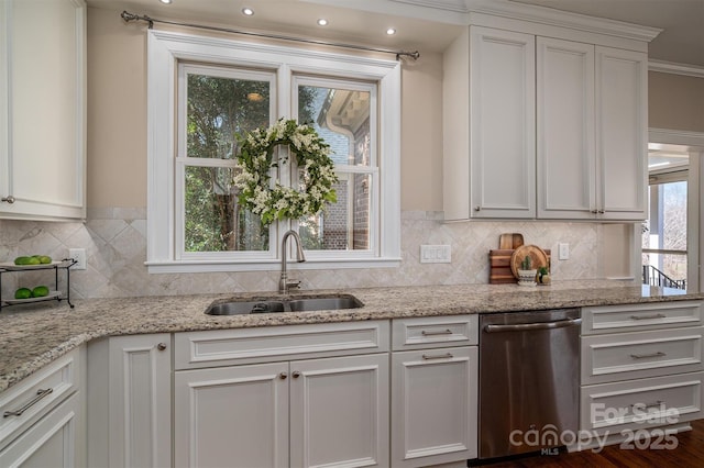 kitchen with a sink, white cabinetry, backsplash, and dishwasher