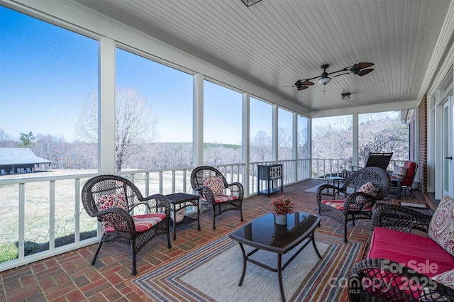 sunroom with wooden ceiling and ceiling fan