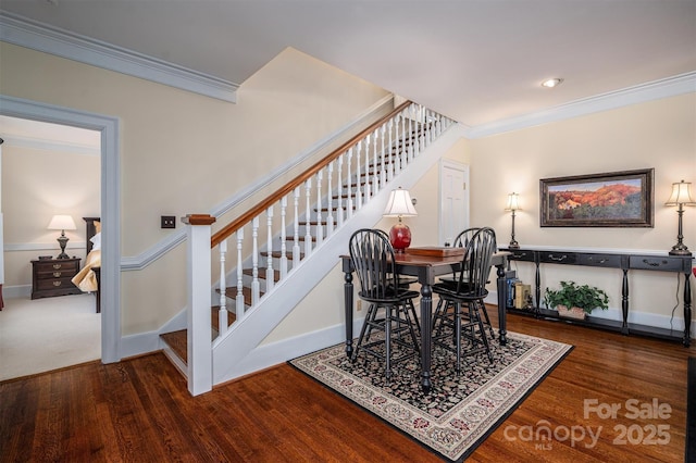 dining room featuring stairway, wood finished floors, and crown molding