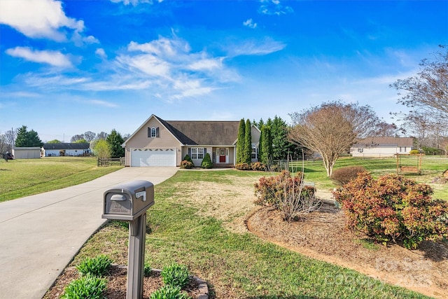 view of front of house featuring a front lawn, fence, a garage, and driveway