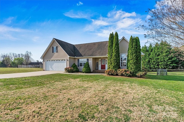 view of front of house featuring a garage, driveway, a front lawn, and fence