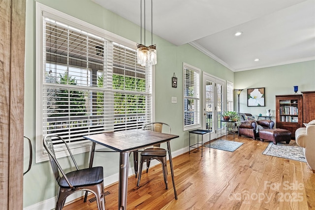 dining room with recessed lighting, baseboards, wood finished floors, and ornamental molding