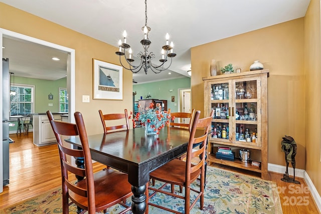 dining area featuring recessed lighting, baseboards, a chandelier, and light wood finished floors