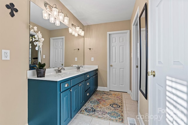 bathroom featuring a sink, visible vents, double vanity, and tile patterned floors