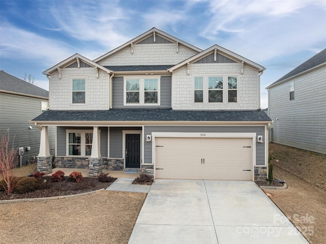 craftsman-style house with covered porch, concrete driveway, stone siding, and an attached garage