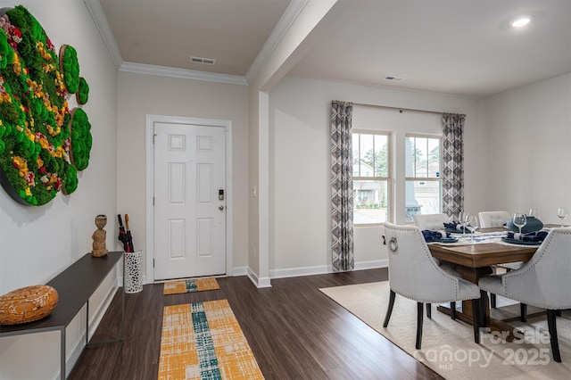 entryway featuring ornamental molding, visible vents, dark wood finished floors, and baseboards