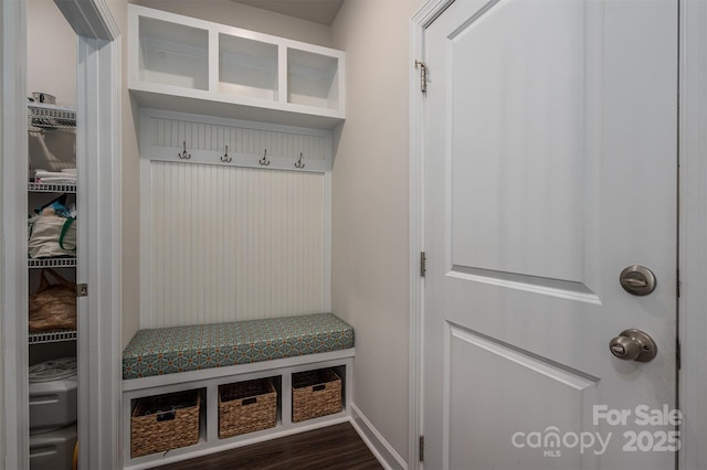 mudroom with dark wood finished floors