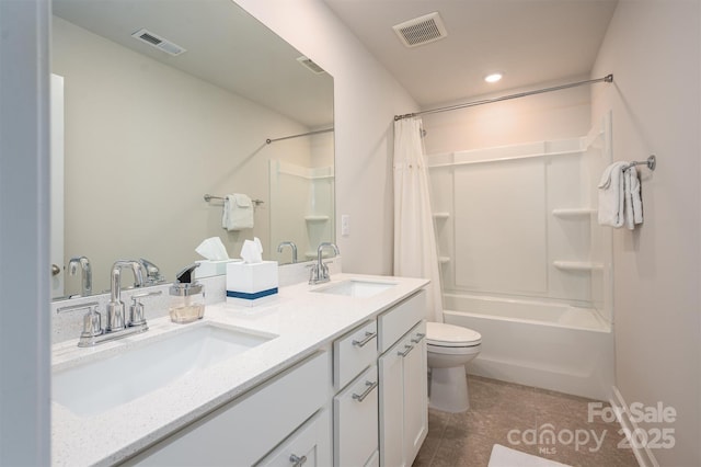 bathroom with toilet, a sink, and visible vents