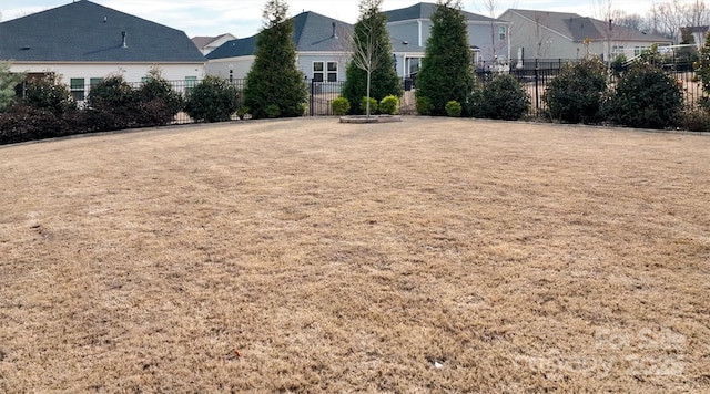 view of yard with a residential view and fence